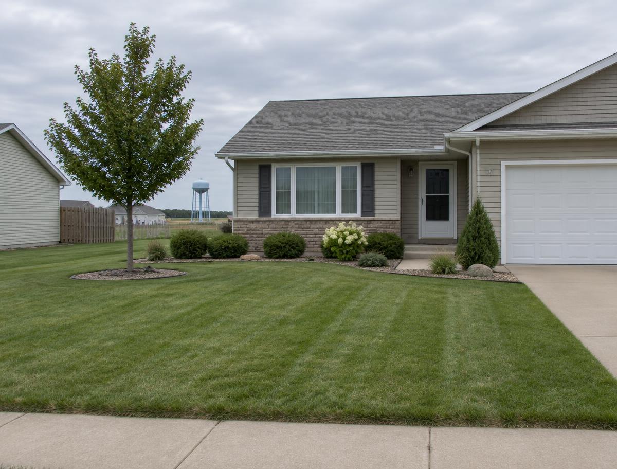 A tidy front yard lawn and simple landscaping at a suburban home